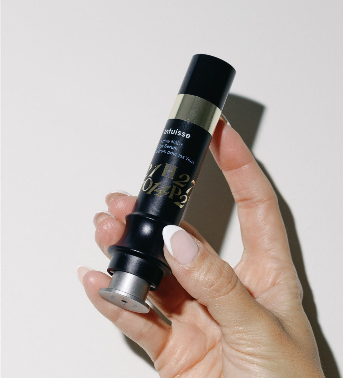 Intuisse Active NAD+ Eye Serum held in hand, showing its size