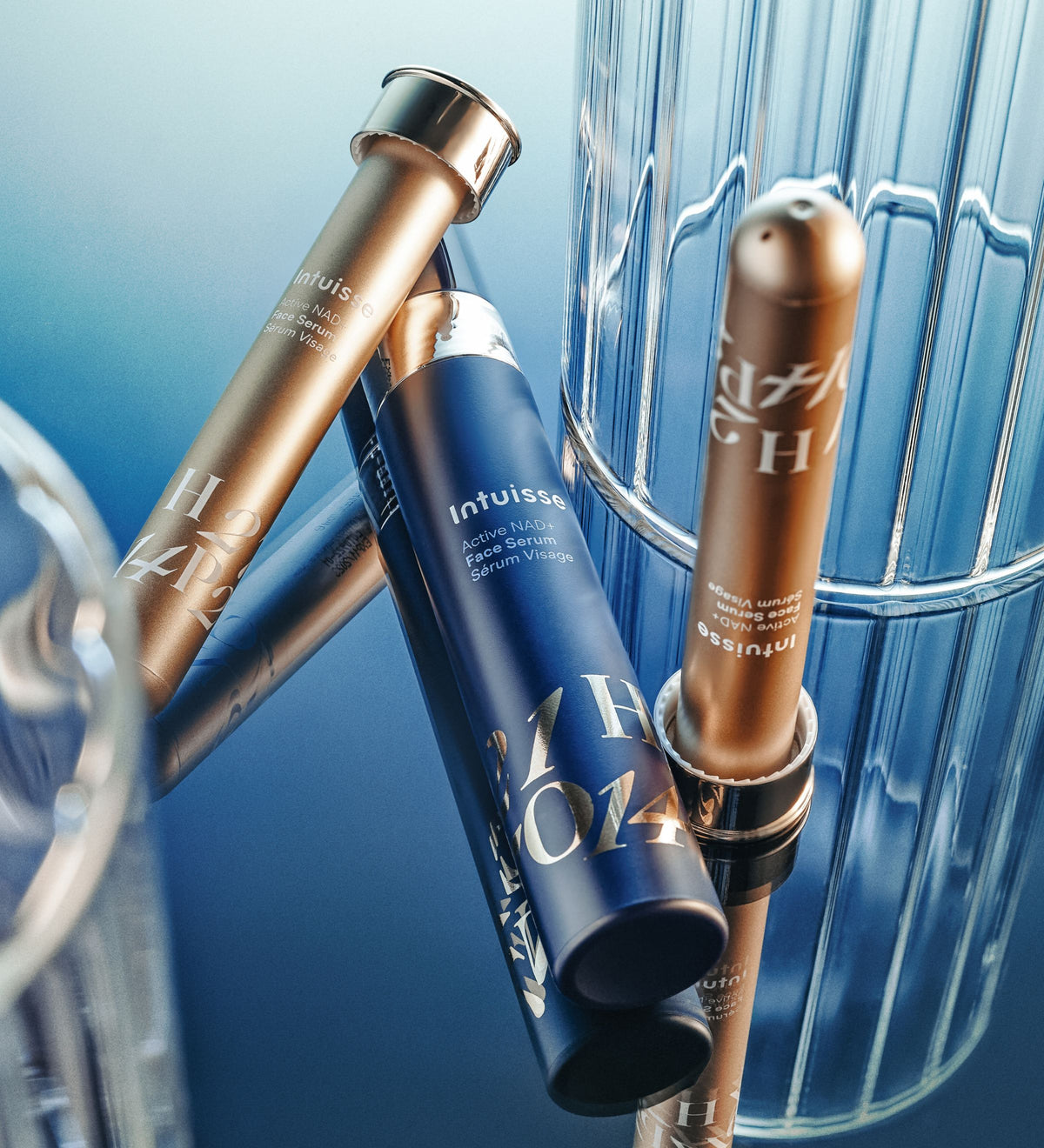 Intuisse Active NAD+ Face Serum and refills against fluted glass.