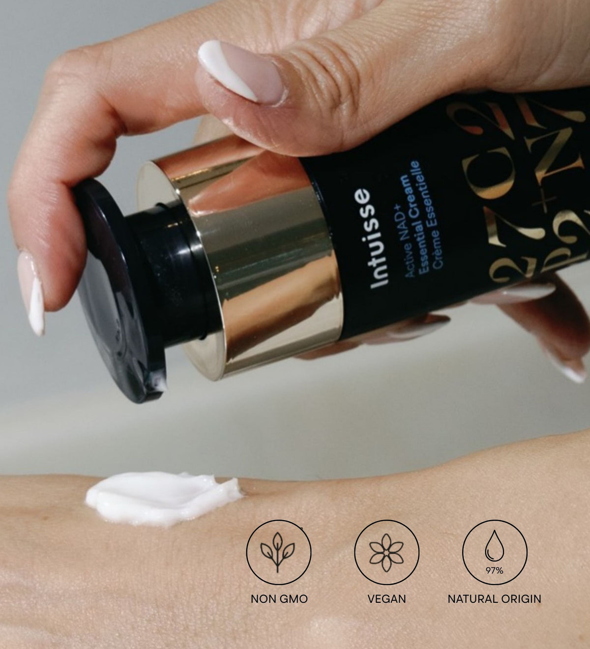 Intuisse Active NAD+ Peptide Essential Cream texture onto the back of a hand; non-GMO, vegan, 97% natural origin