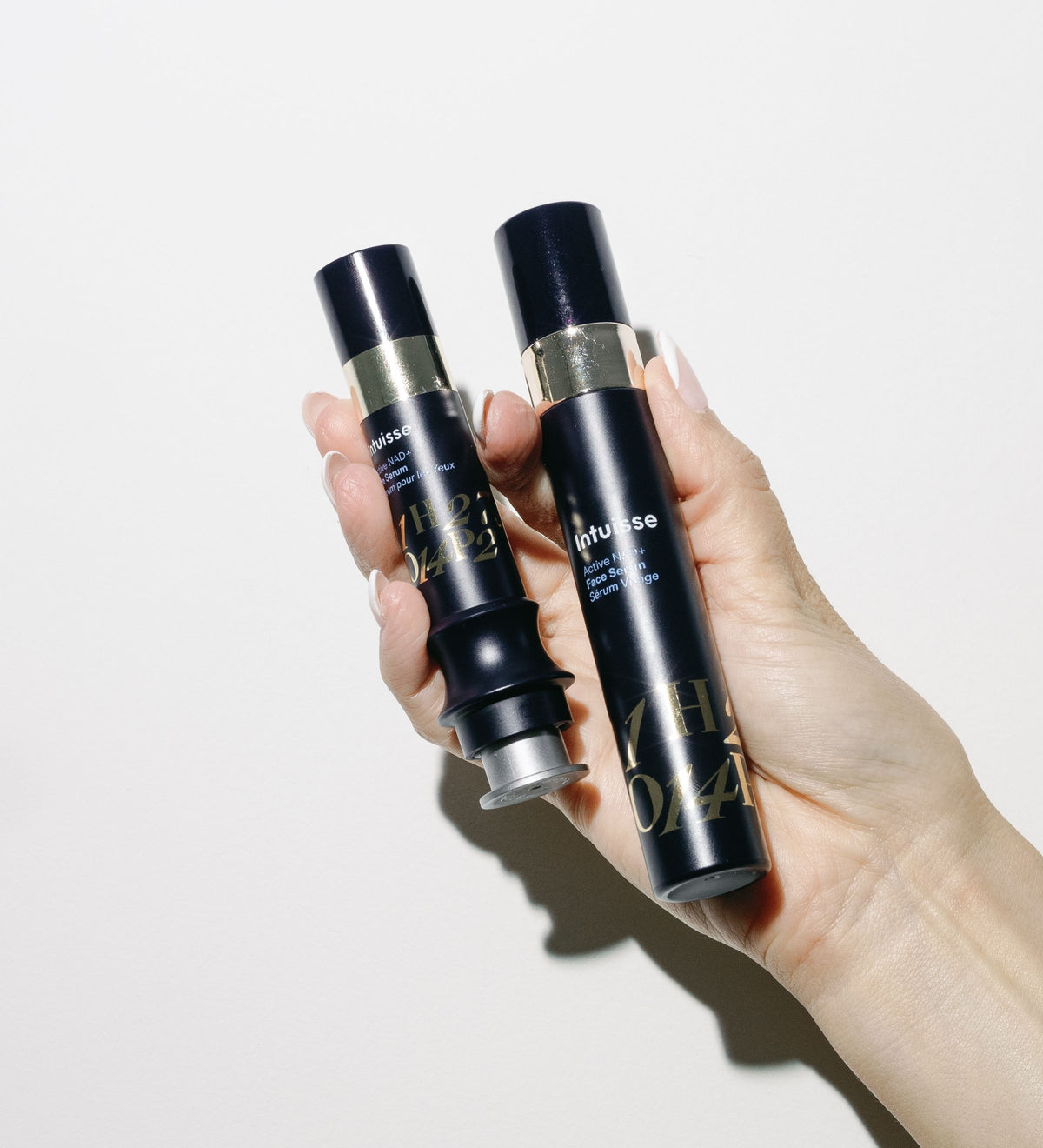 Intuisse Active NAD+ Face Serum and Eye Serum held in hand