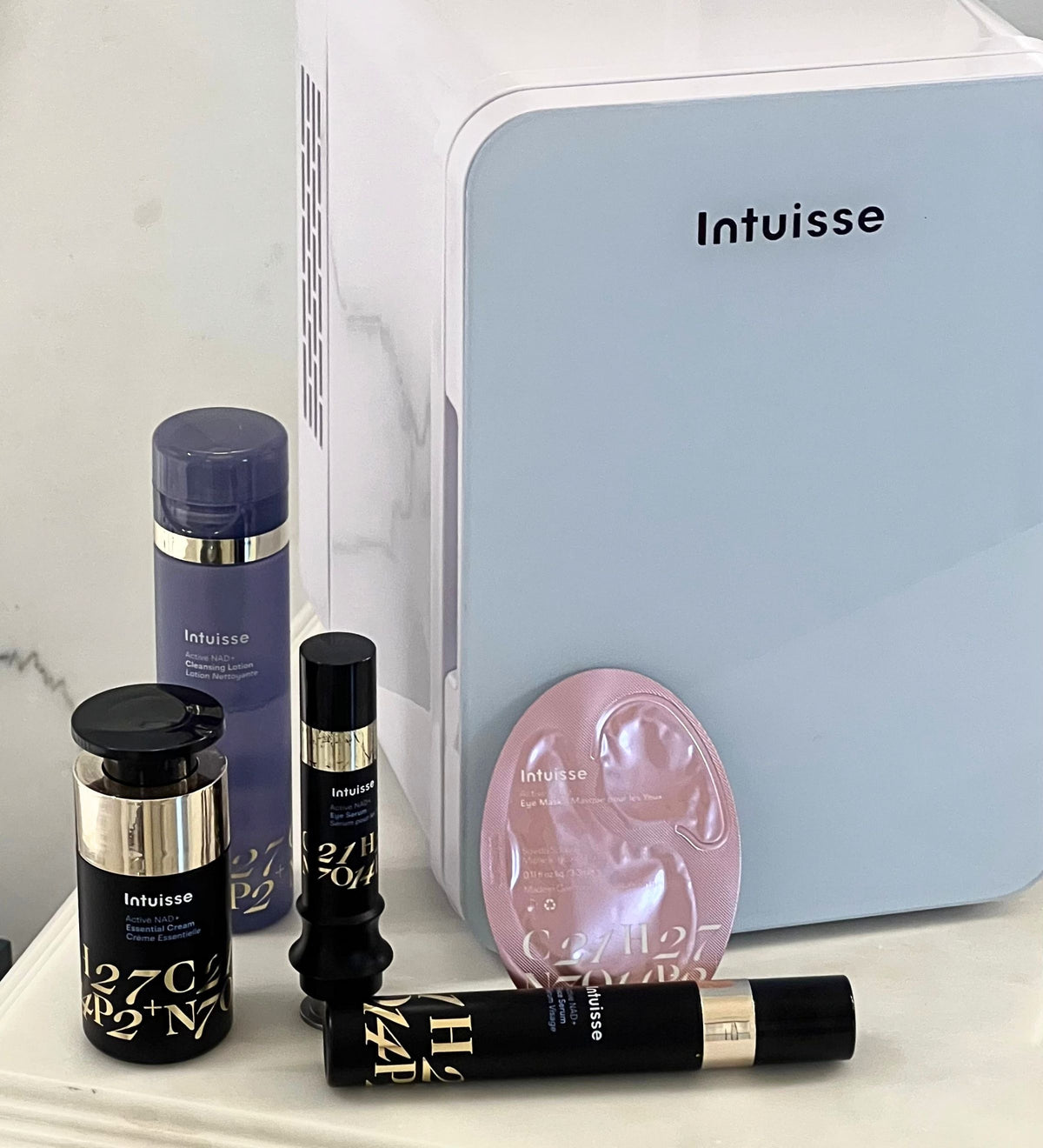 Intuisse skincare fridge beside the Active NAD+ Face Serum, Eye Serum, Essential Cream and Collagen Eye Mask