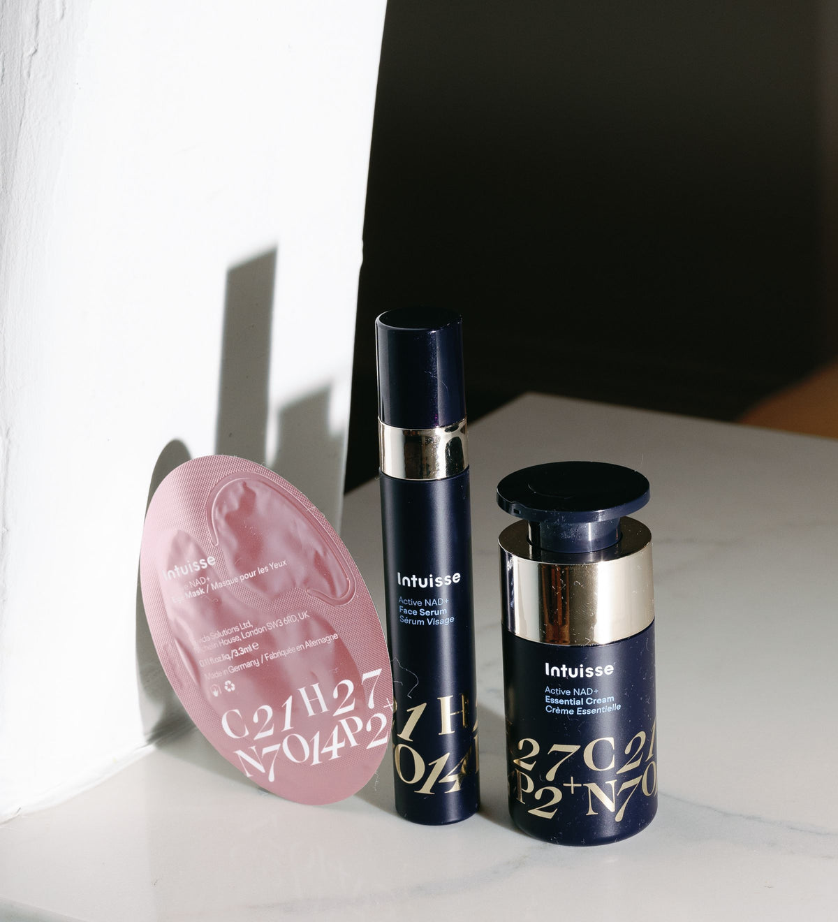 Intuisse Starter Kit products arranged together, showing the NAD+ Face Serum, Essential Cream and Collagen Eye Mask